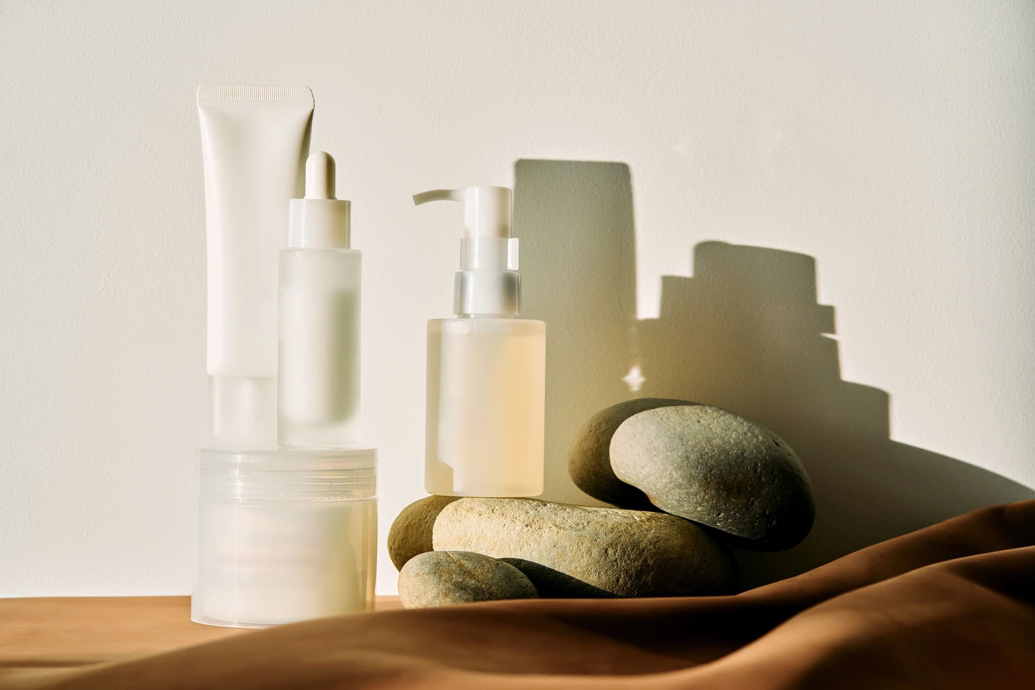 Minimal skincare product flatlay in sunlight